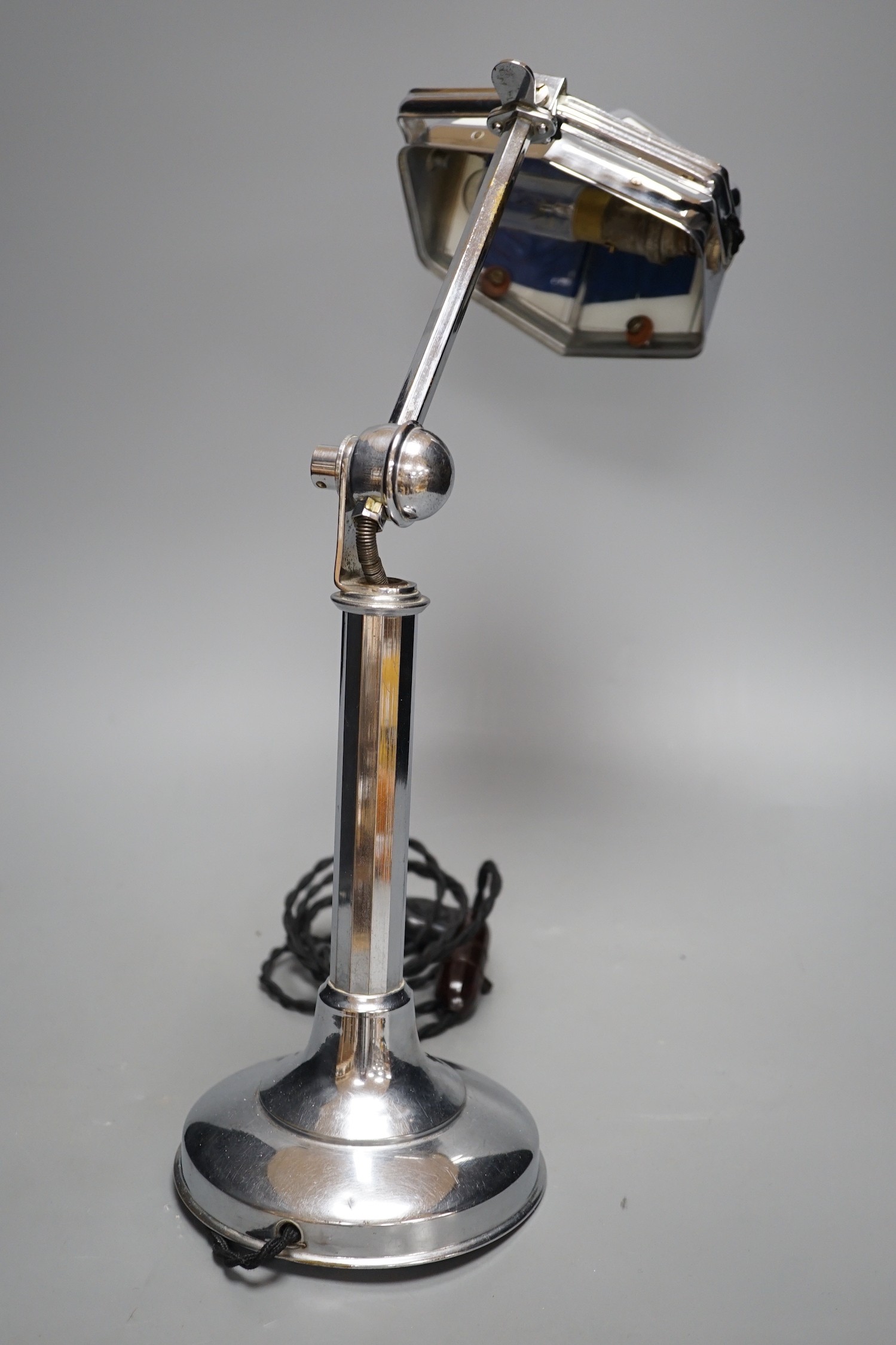 A chrome pirouette adjustable desk lamp